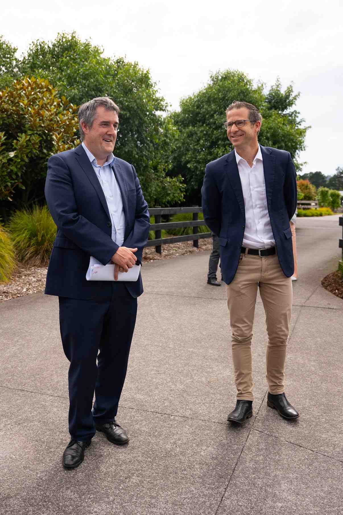 Building and Construction Minister speaking with colleague at a new housing development